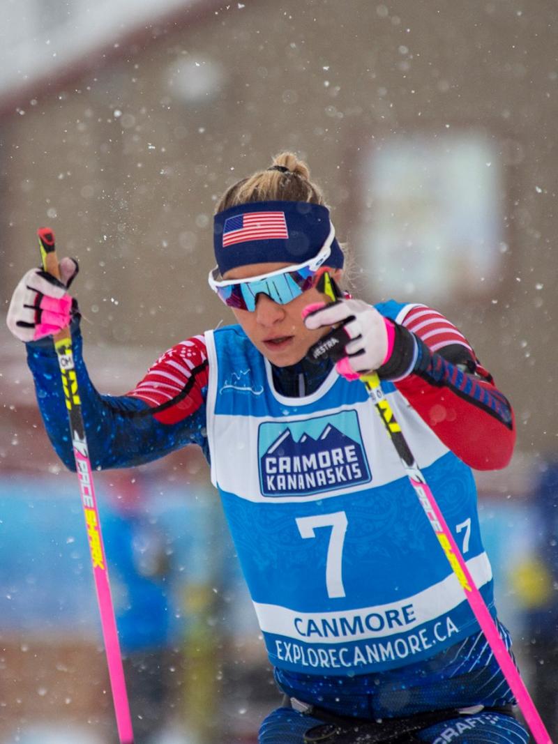 A woman competing in a Para cross-country race under snow