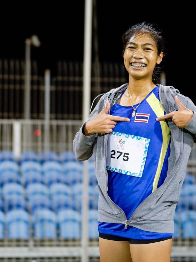 An athlete showing the flag of Thailand on her uniform