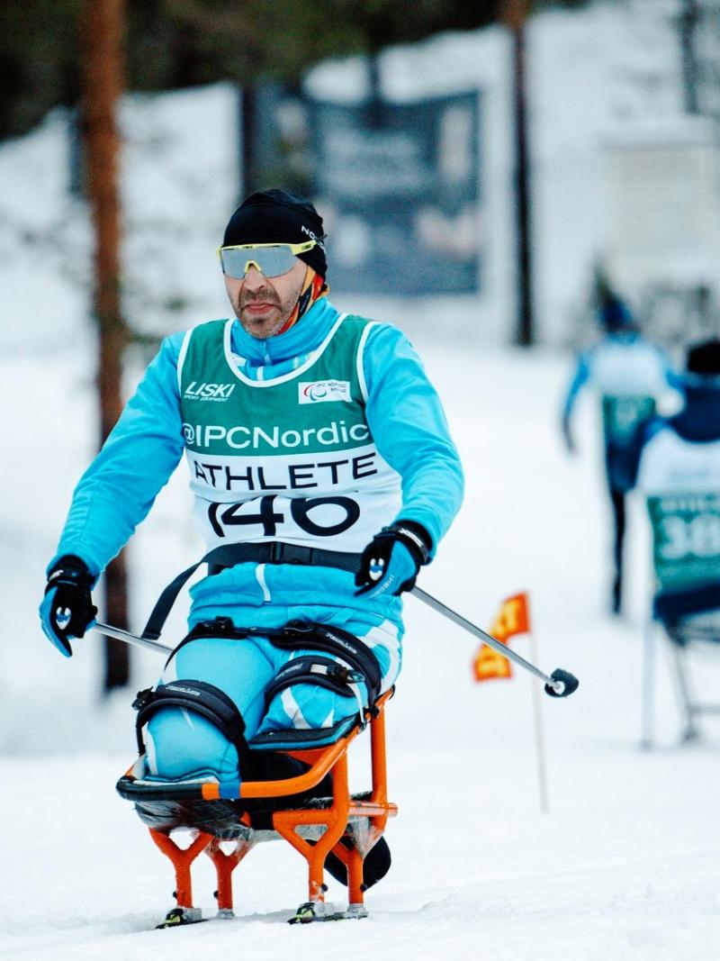A male sit skier in a cross-country skiing competition