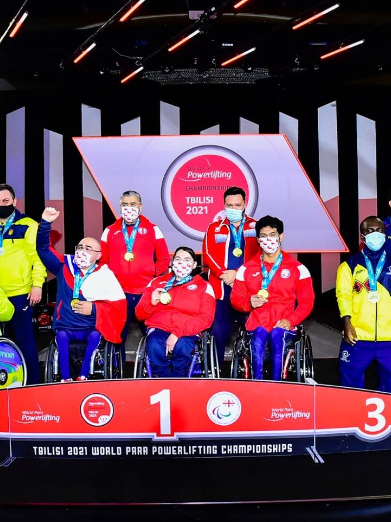 A group of athletes from Ukraine, Chile and Colombia on a podium