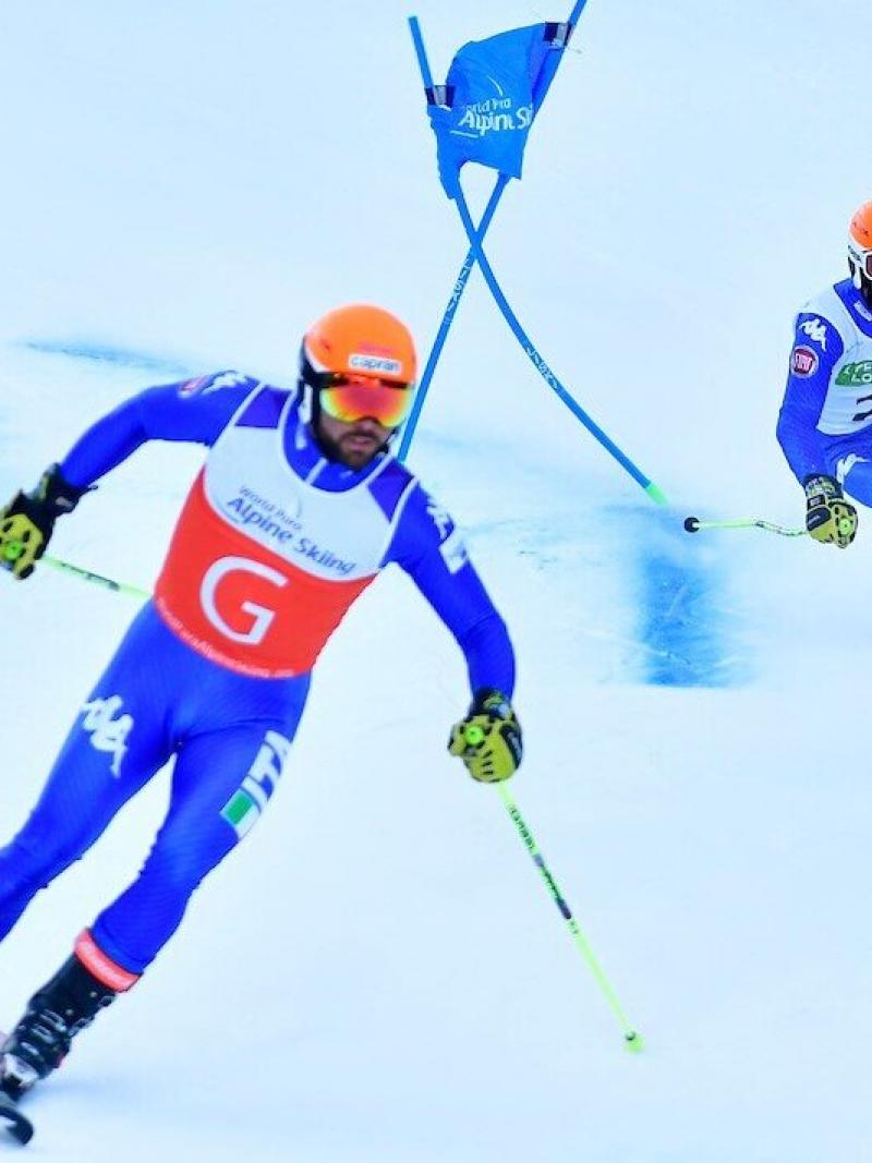 A guide leading the vision-impaired skier during the race