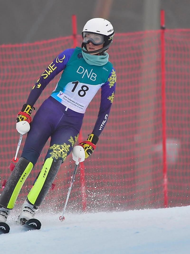 A female alpine skier on a course