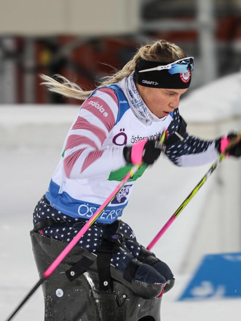 A female sit-skier in a Para cross-country skiing competition