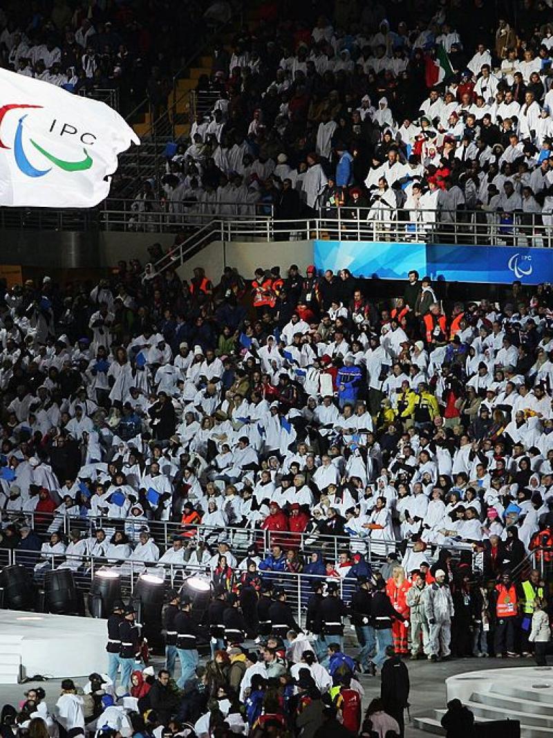 The International Paralympic Committee flag and the Italian national flag fly side by side during the Opening Ceremony of the Turin 2006 Paralympic Winter Games. 
