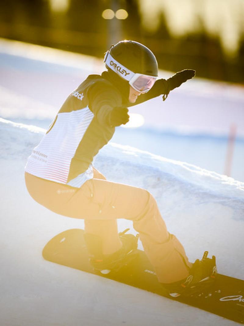 Image of a female Para Snowboard in a competition