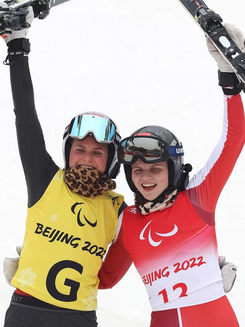 Veronika Aigner and guide and sister Elisabeth Aigner react after winning the giant slalom gold medal