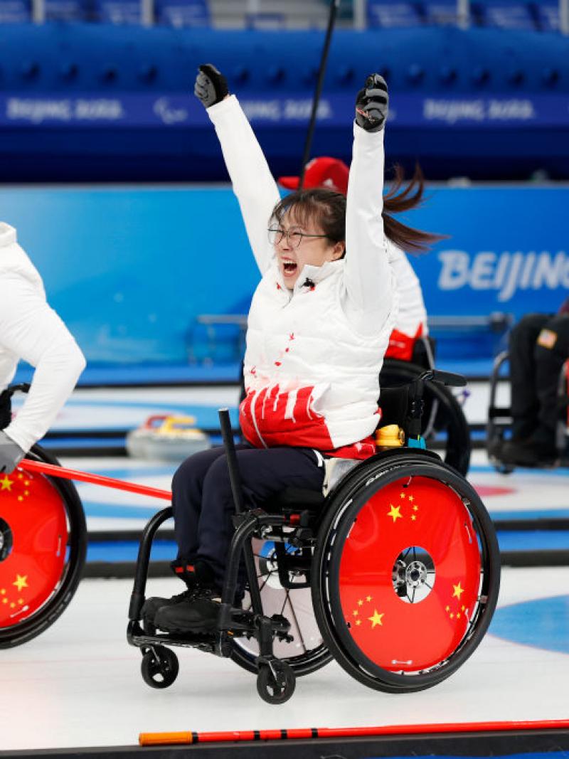 Chinese wheelchair curlers cheers with their arms in the airGett