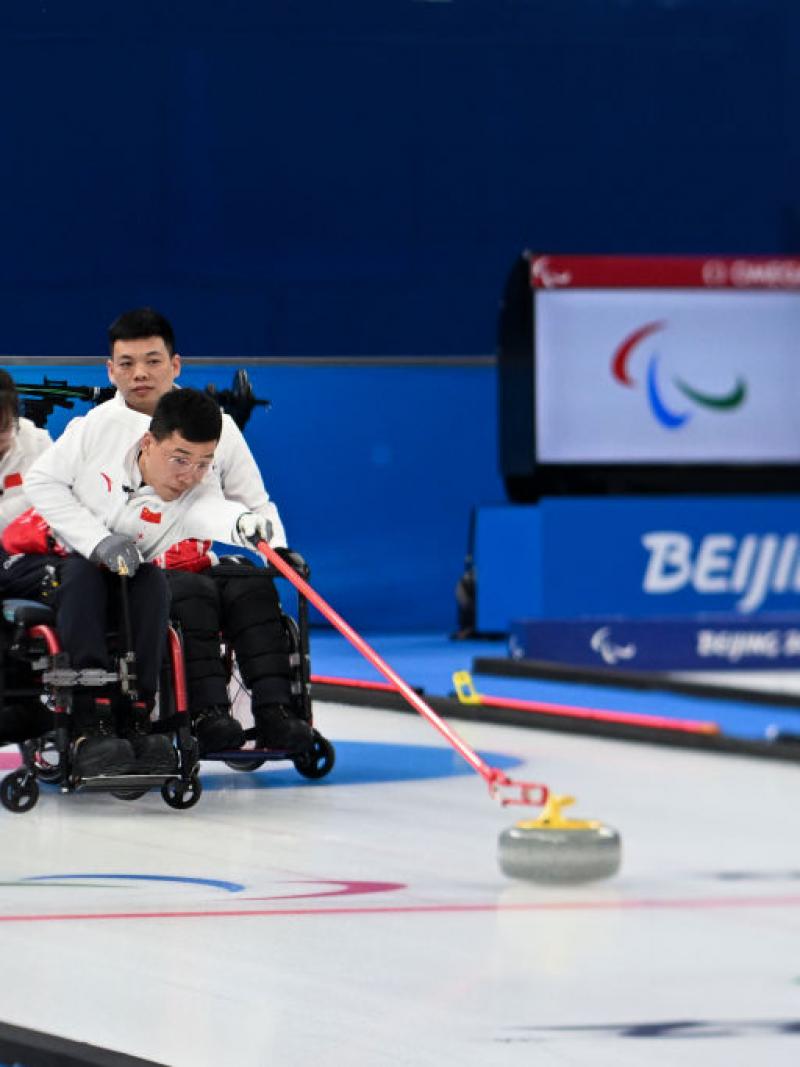 A Chinese wheelchair curler releases a stone