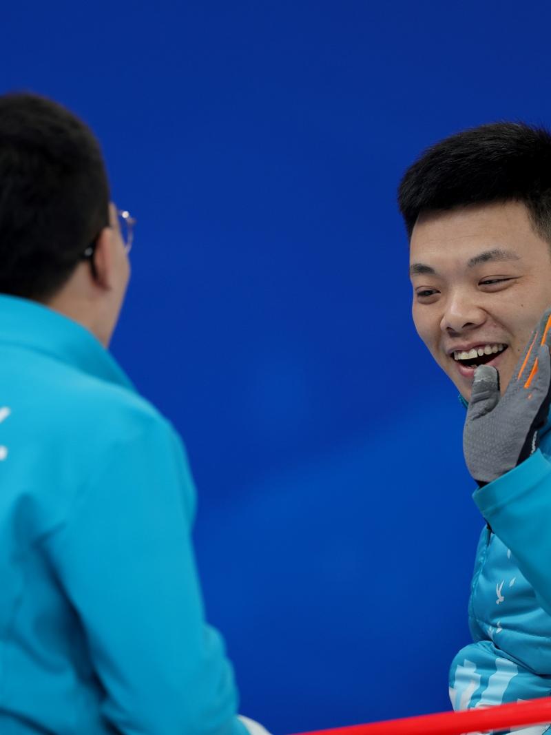 Chinese Wheelchair Curling team members celebrate during one of their Beijing 2022 matches