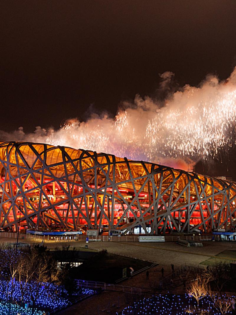 Fireworks emerge from the top of the Birds Nest National Stadium with its metal exoskeleton during the closing ceremony of Beijing 2022