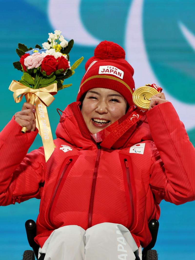 Japanese sit-skier Momoka Muraoka celebrates with her gold medal 