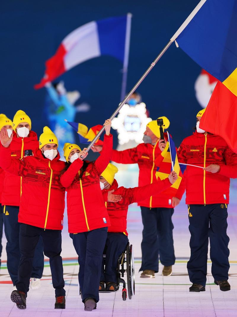 Laura Valeanu and Mihaita Papara carry the Romanian flag at the Opening Ceremony of Beijing 2022