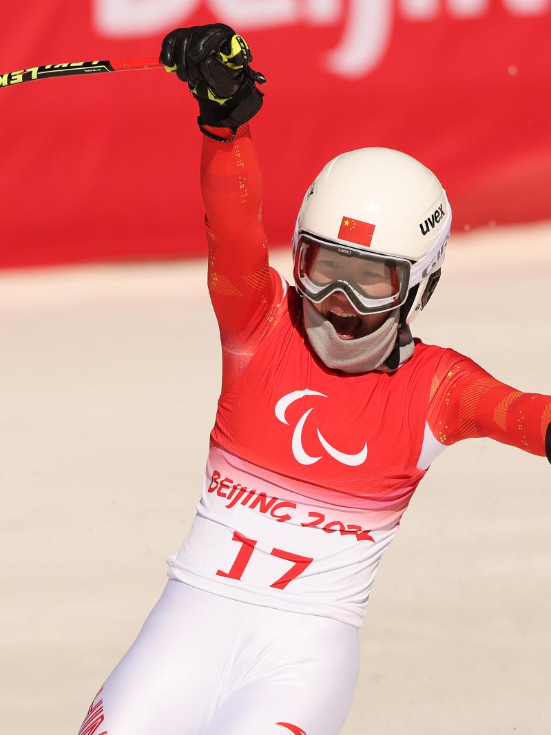 Zhang Mengqiu reacts with joy after finishing her race in Beijing