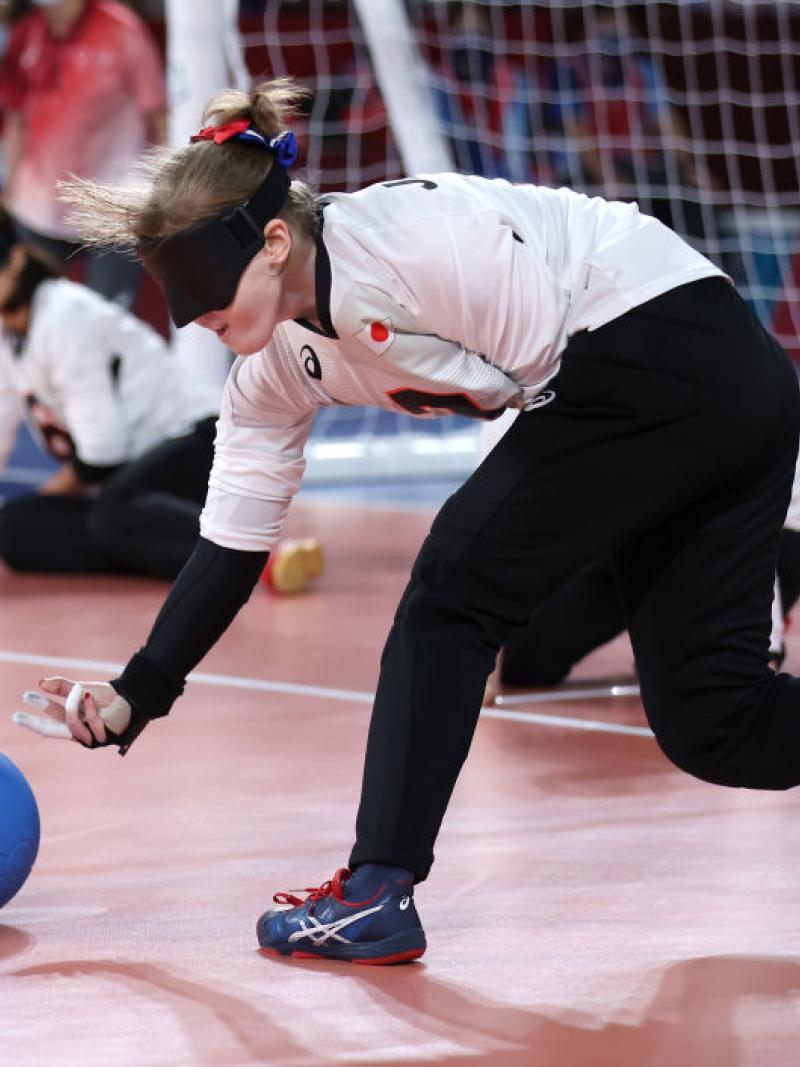 Japan's Eiko Kakehata releases the ball to the ground, fingers outstretched, as she shoots during her team's semifinal match against Team Brazil at the Tokyo 2020 Paralympic Games.