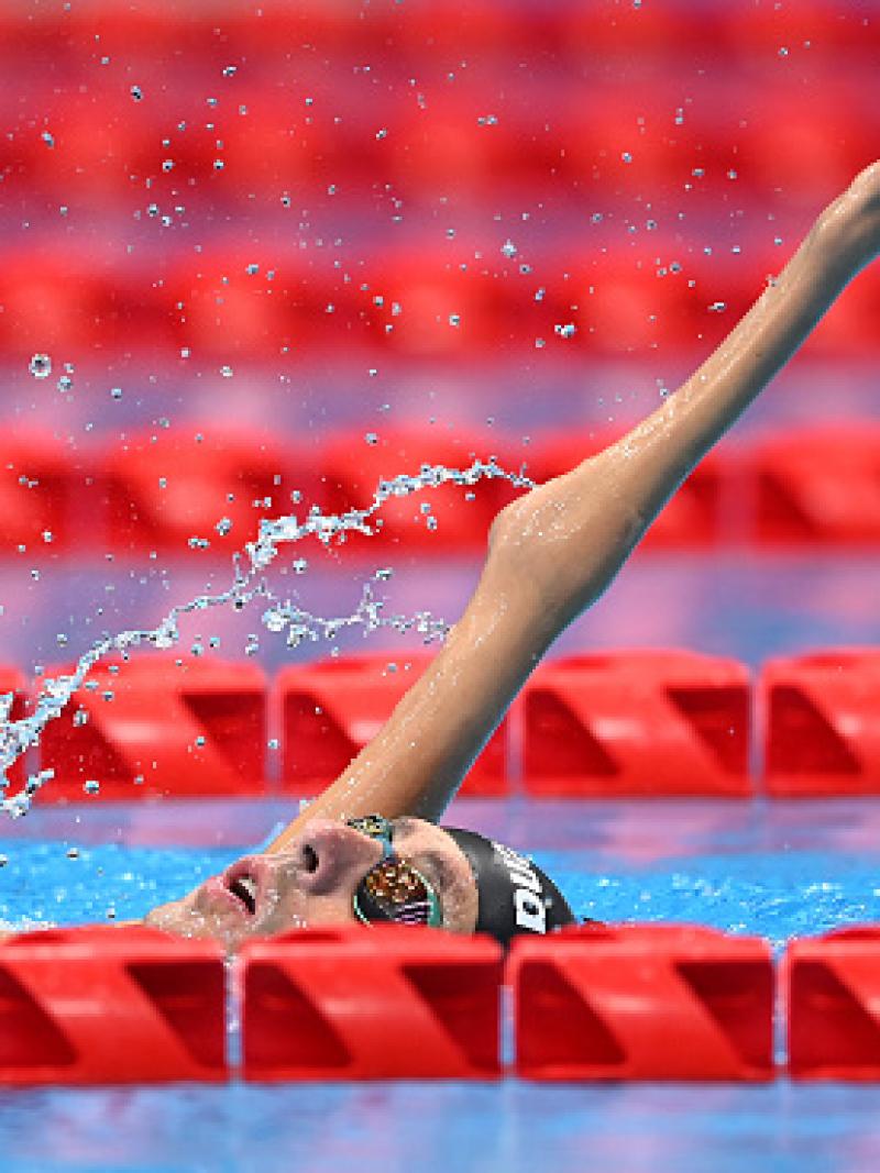 A male Para swimmer competing in a backstroke event