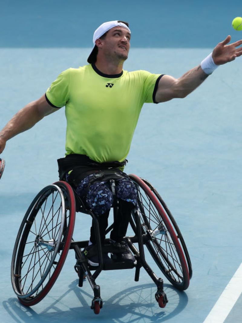 Argentina's Gustavo Fernandez serves in a doubles match at the 2022 Australian Open.
