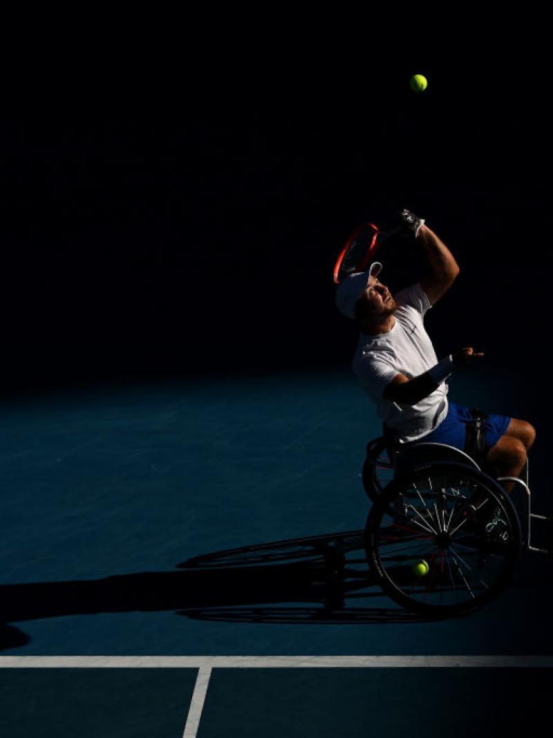 Dutch player Sam Schroder casts a shadow as he serves in the Australian Open final against Australia's Dylan Alcott.
