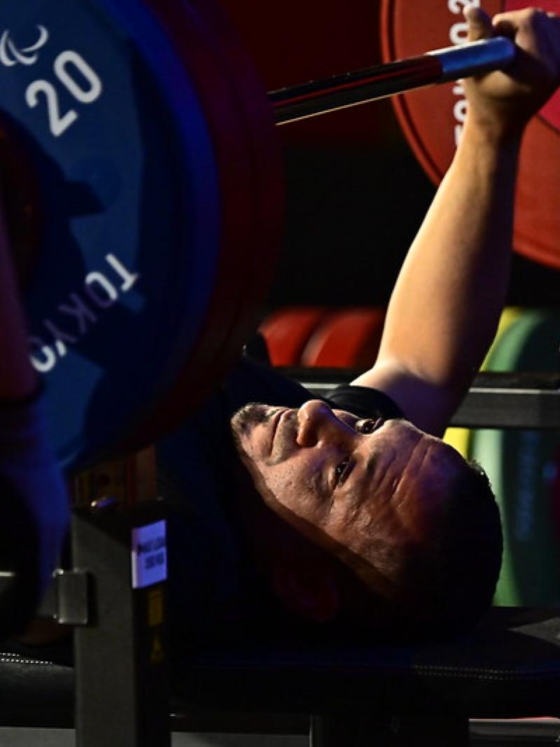 A man preparing to lift a bar on a bench press