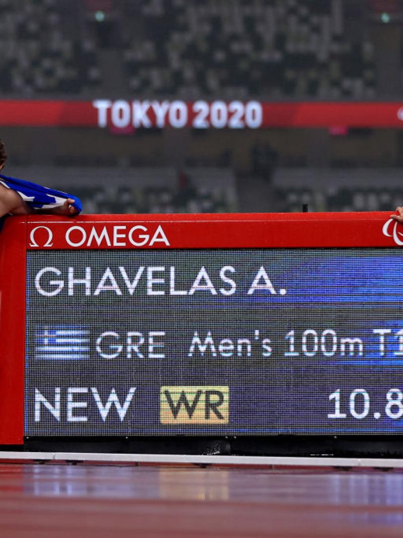 Image of a male Para Athletics and his guide near to their time on the track