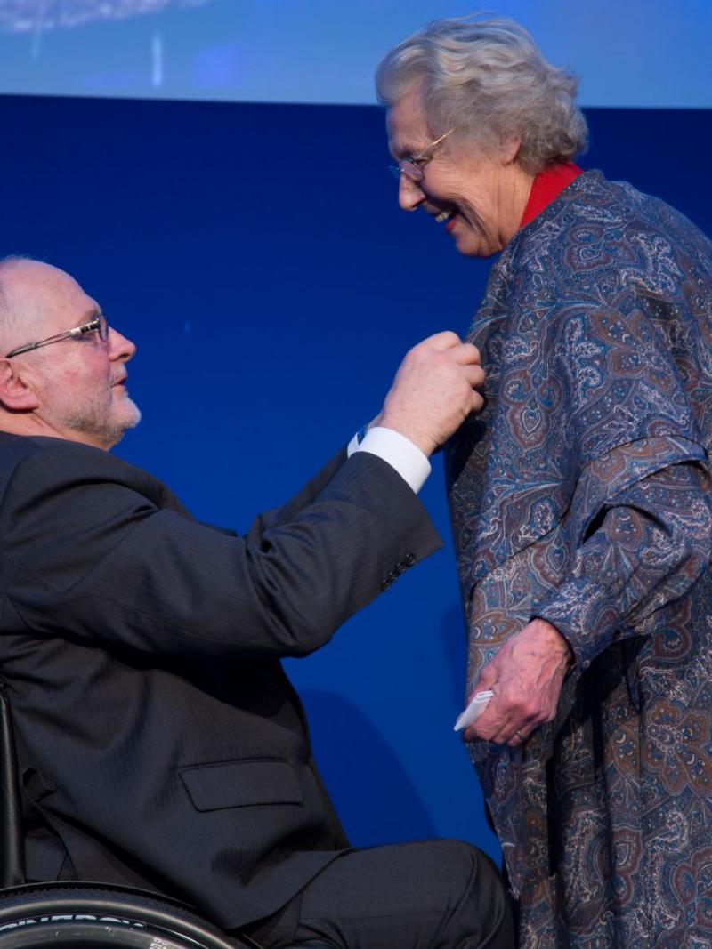 Sir Philip Craven presents the Paralympic Order to a smiling Jonquil Solt.