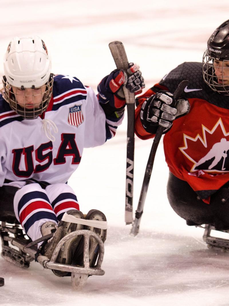 Image of two female Para ice Hockey players on the ice