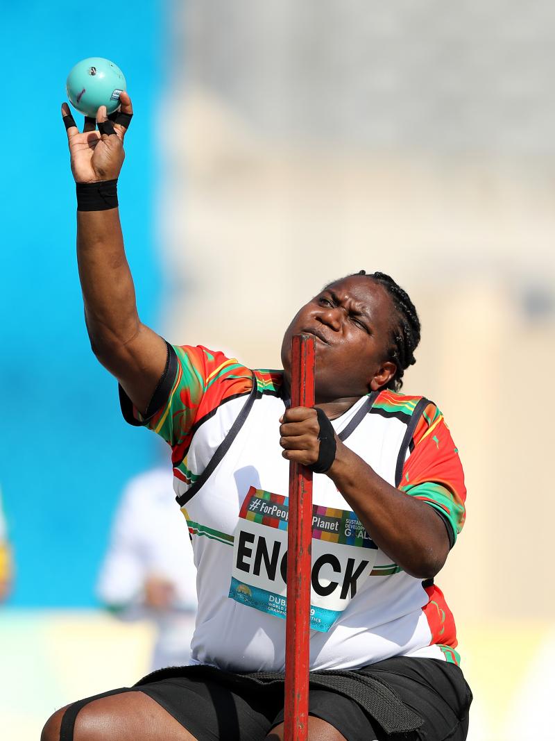 A woman about to make a throw in a seated shot put competition.