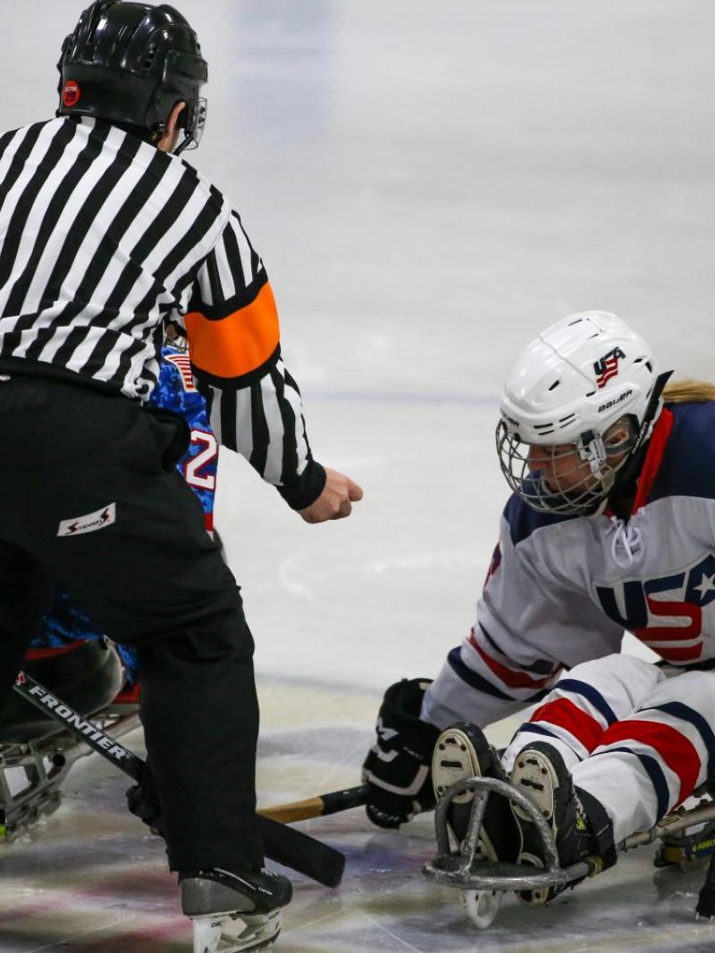 Image of a female para hockey player from USA on the ice for the beginning of the match