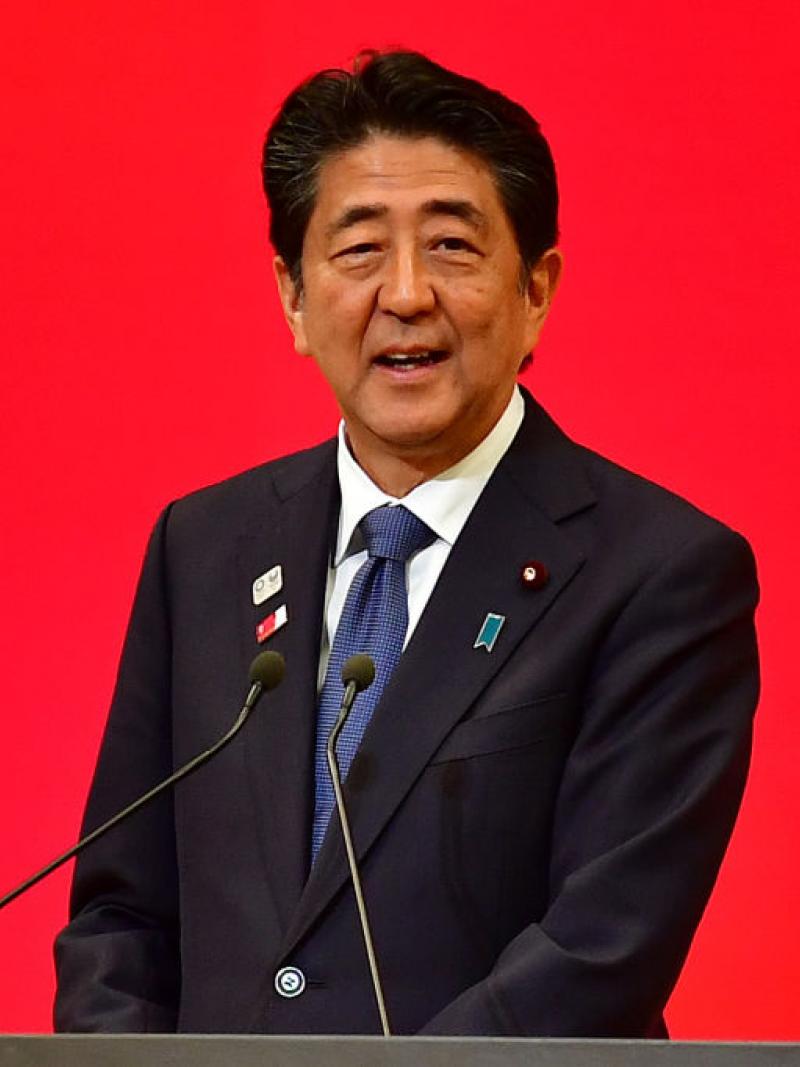 Photo of Japanese male Prime Minister speaking on podium