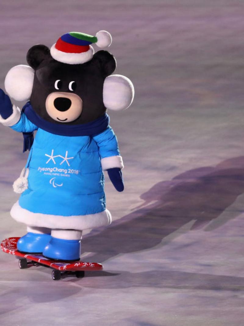A PyeongChang 2018 mascot rides a skateboard and waves during the Games Opening Ceremony.