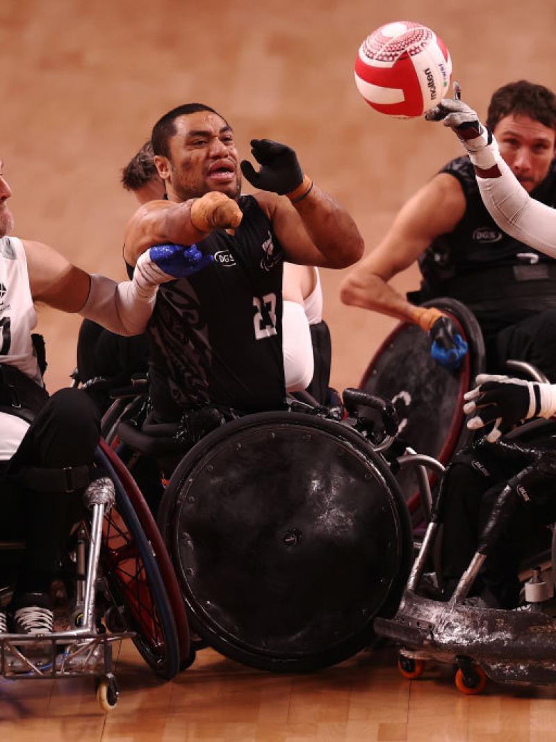 Five players from the Denmark and New Zealand teams battle for the ball.
