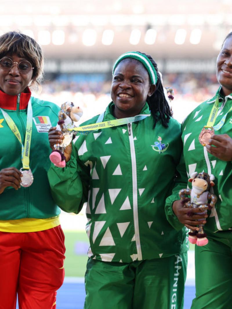  Eucharia Iyazi (centre) of Nigeria with her team mate and bronze medallist Ugochi Alam and silver medallist Arlette Mawe Fokoa of Cameroon pose for a photo during the medal ceremony for the women's shot put F55-57 at the Birmingham 2022 Commonwealth Games.