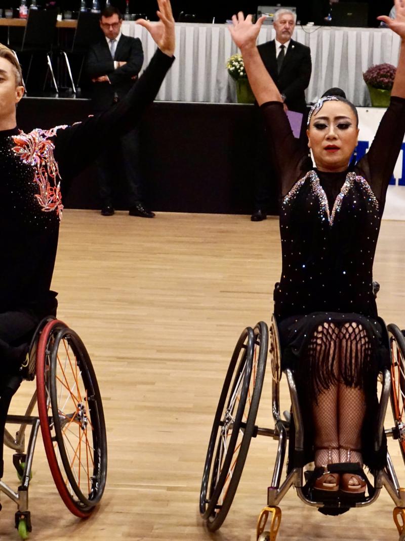 A male and a female wheelchair dancers side by side in a presentation
