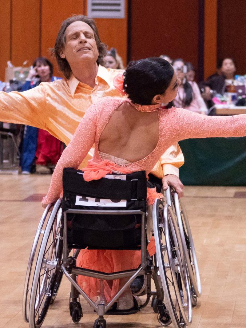 A pair of wheelchair dancers in a competition