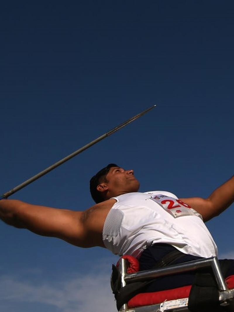 A male athlete in a chair competing in javelin throw