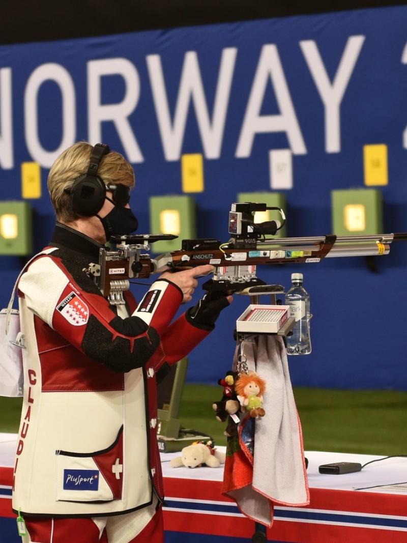 A female vision impaired shooter and her assistant in a competition