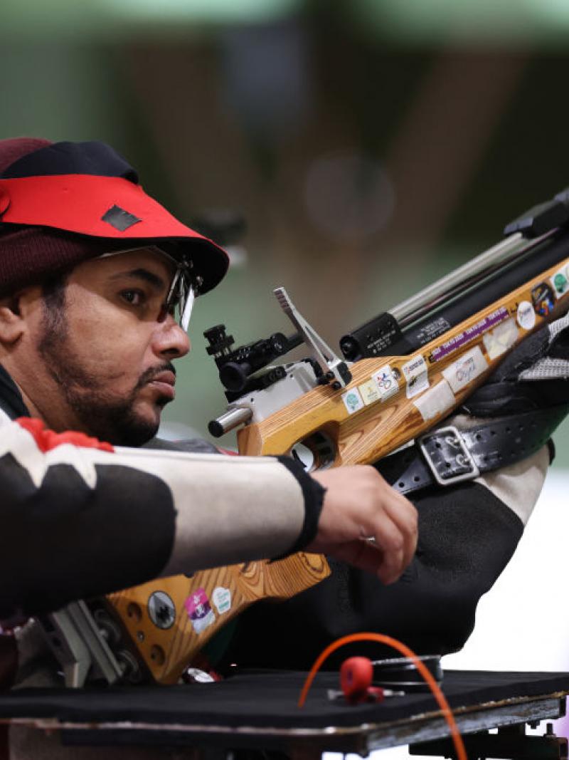 A male shooter with a rifle in a shooting range