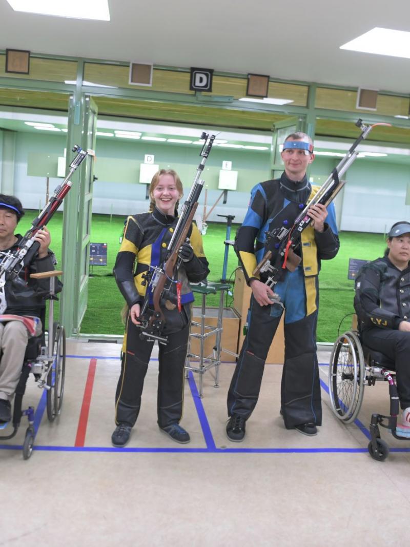 Medallists strike a pose after the end of the R10 - 10m air rifle standing mixed team SH1 finals at the Al Ain Equestrian, Shooting and Golf Club.