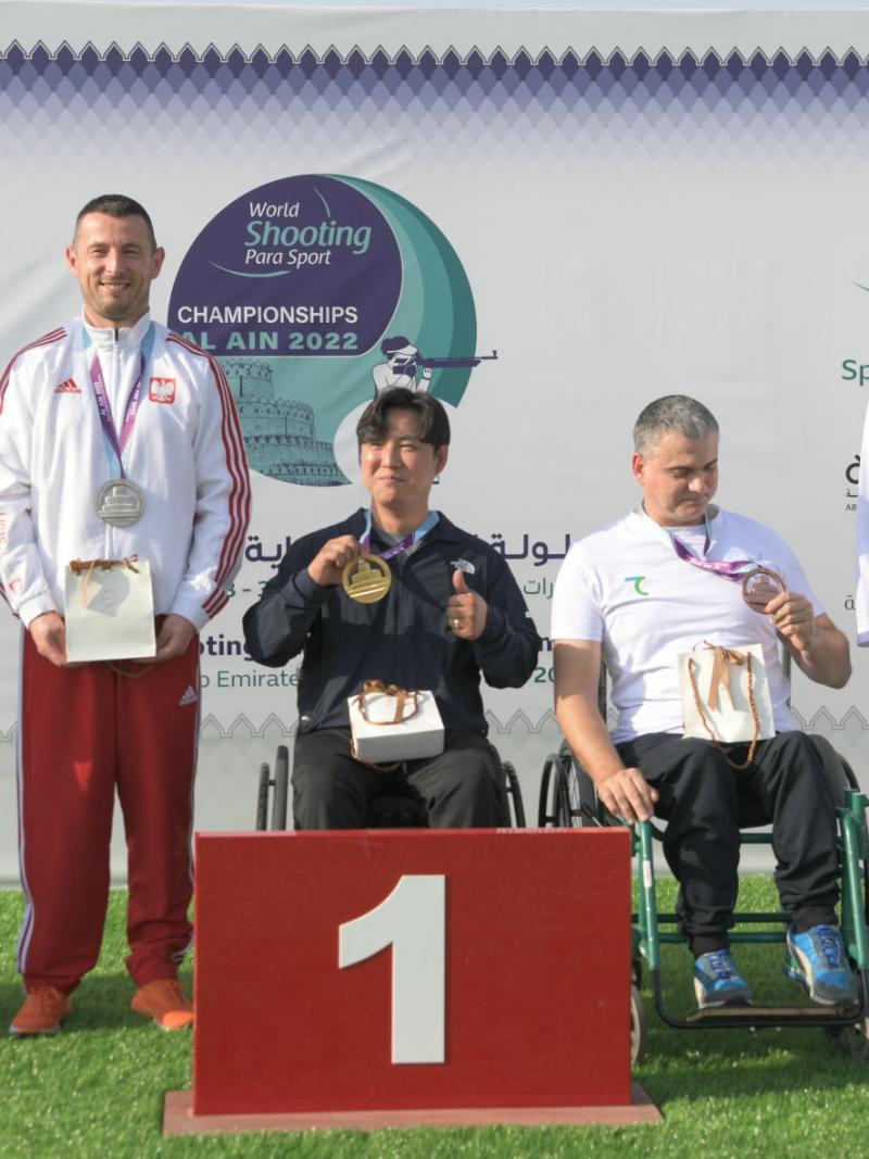 The medallists of P1- men's 10m air pistol SH1 poses with their medals on the podium of the Al Ain 2022 World Shooting Para Sport Championships.