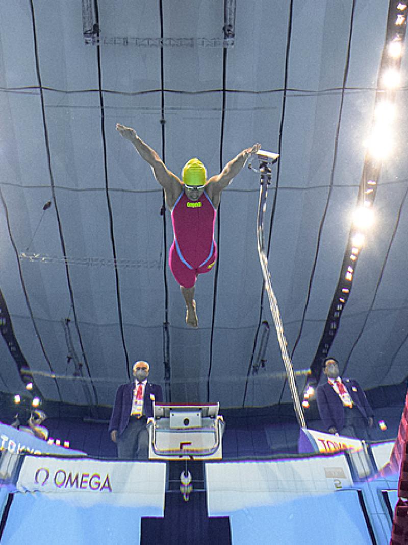 An underwater image of three female Para swimmers jumping in the water at the Tokyo 2020 Paralympic Games