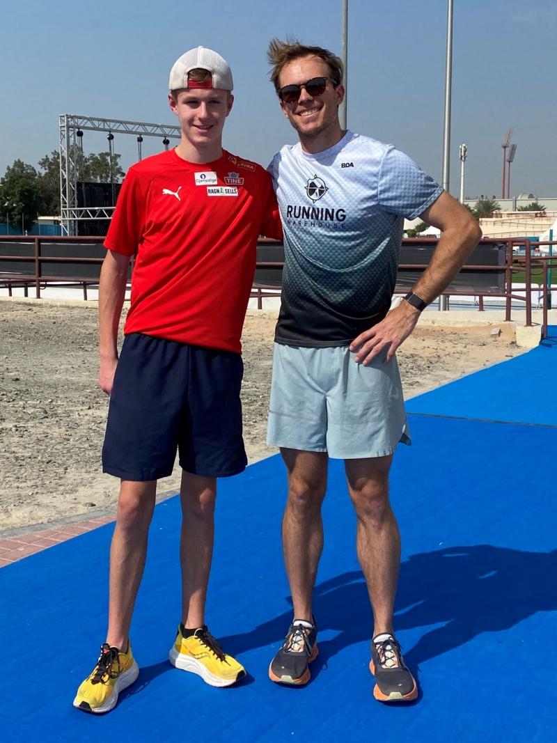 Two male athletes posing for a photograph.