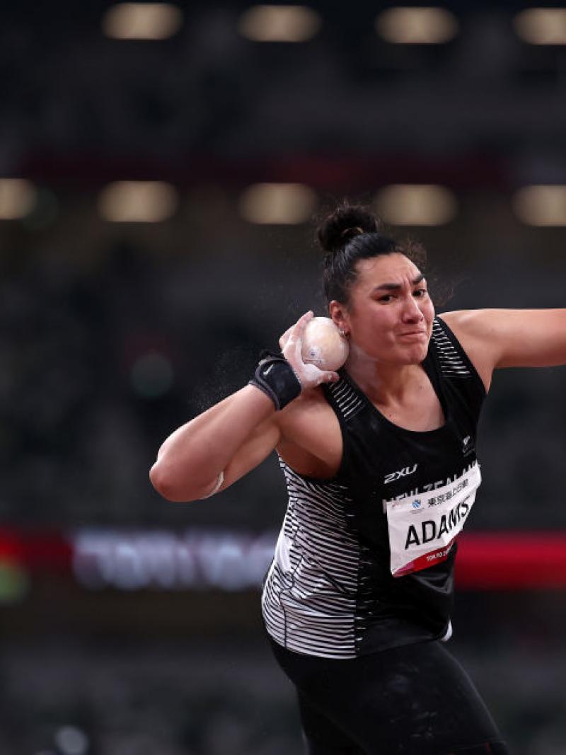 A female athlete competing in shot put