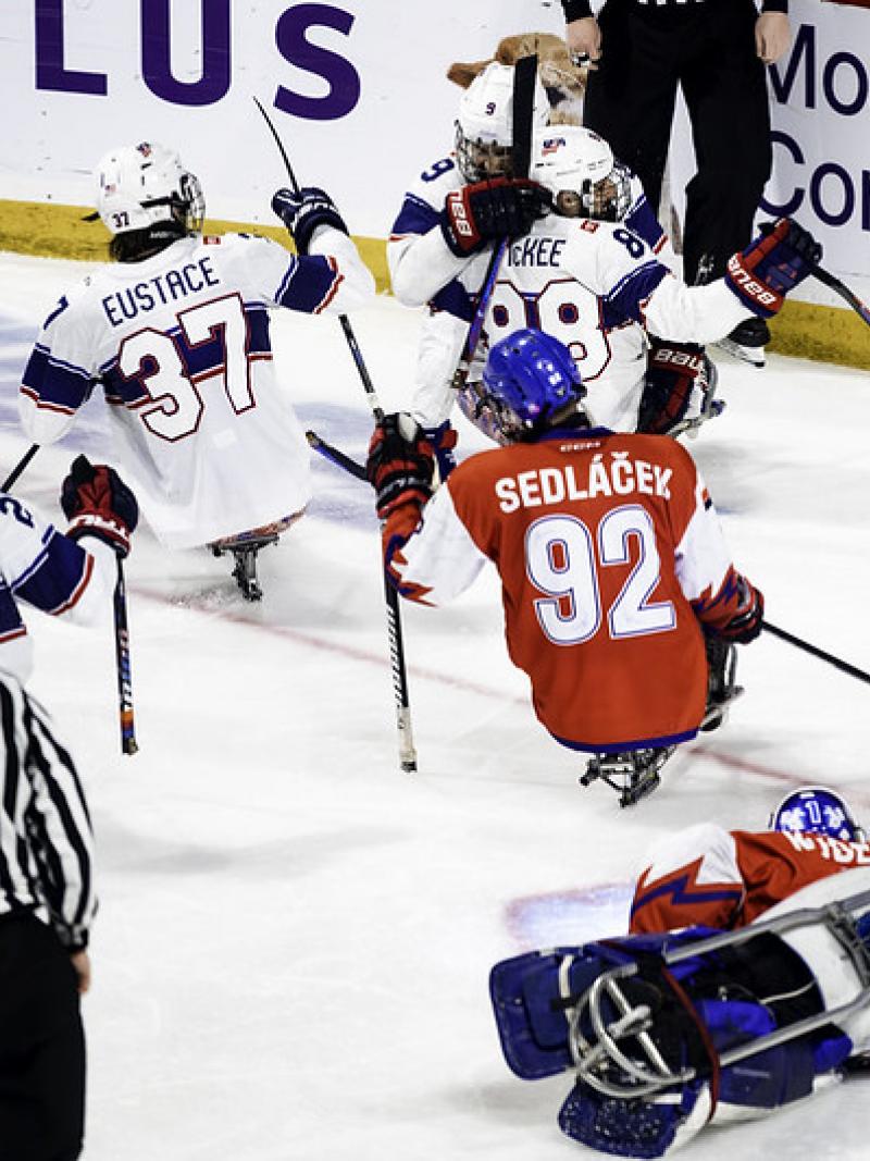 Four US Para ice hockey players celebrating against Czechia 