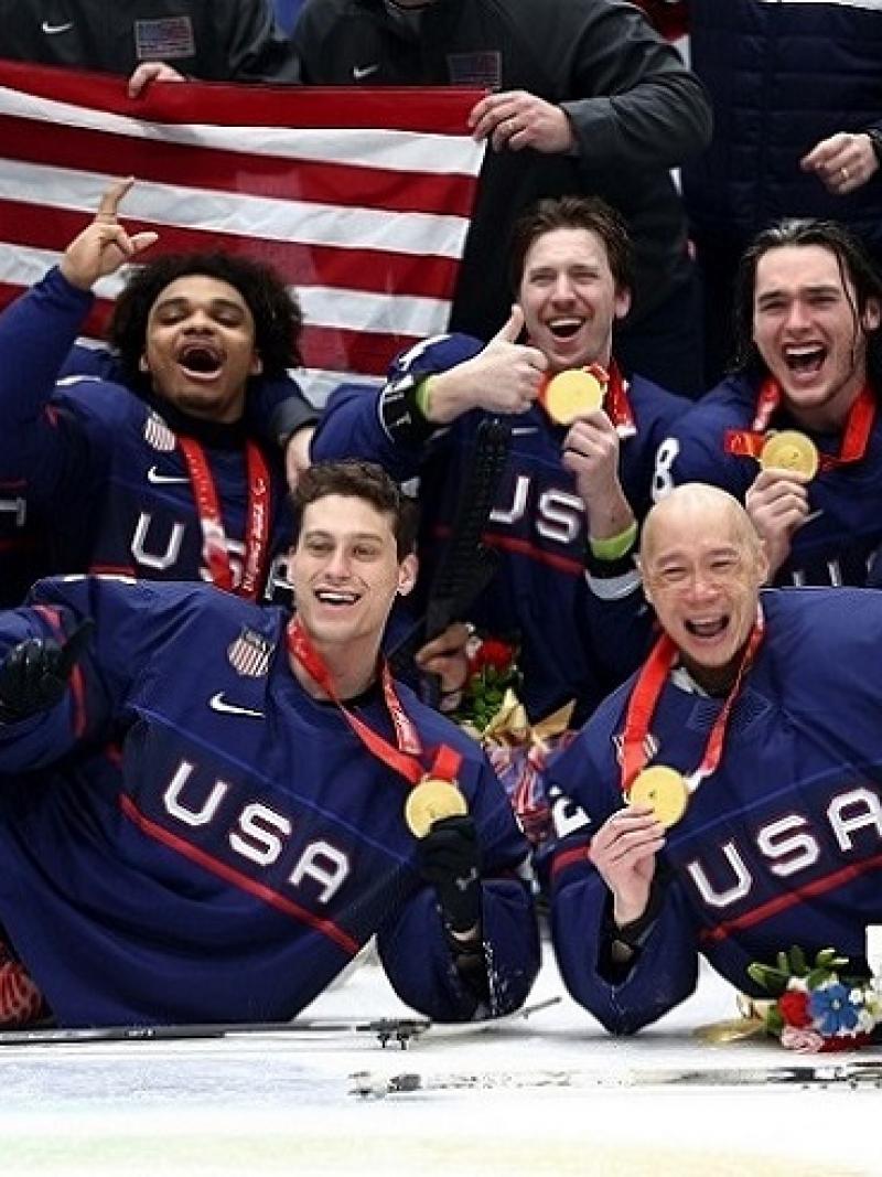 The USA Para ice hockey national team celebrating on ice