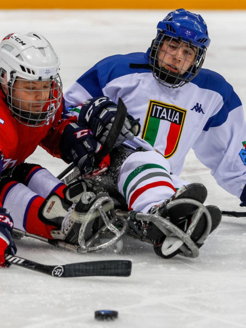 Two male Para ice hockey players competing on ice