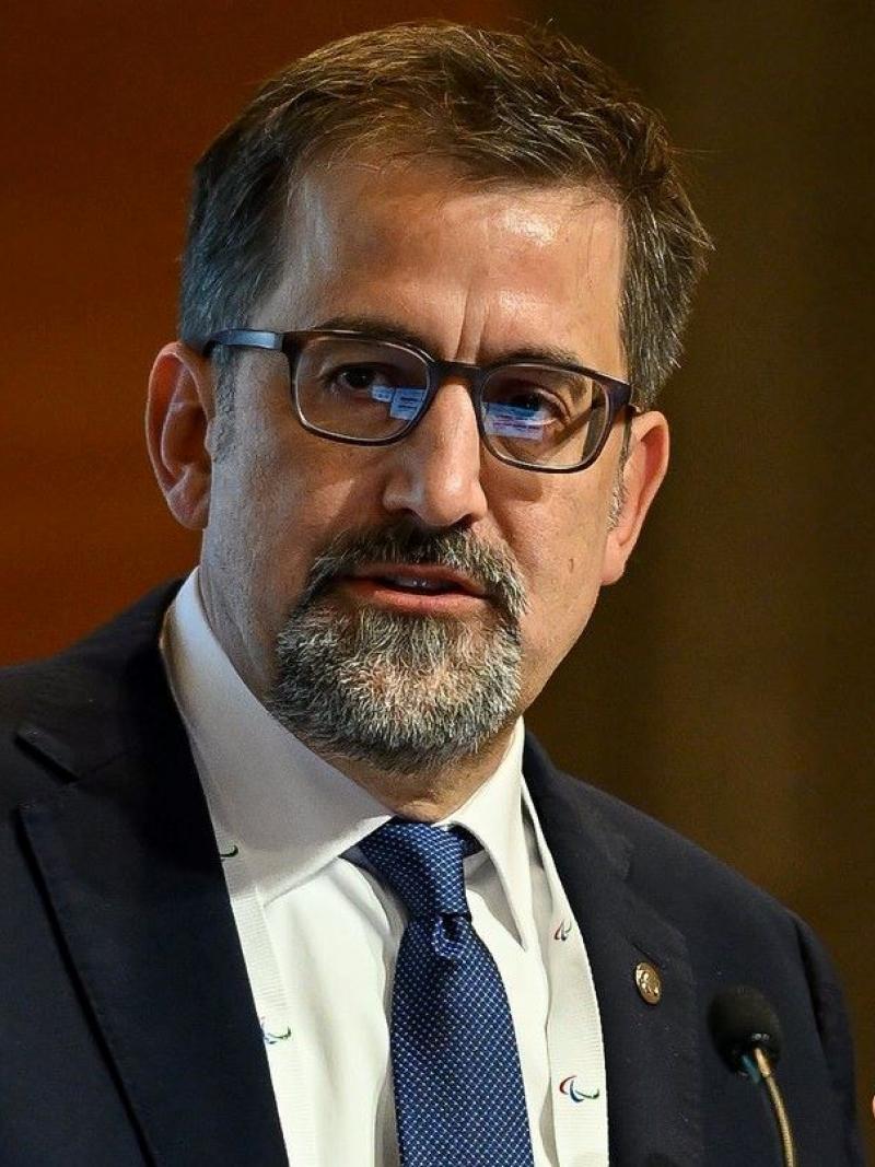 A man wearing a suit making a speech.