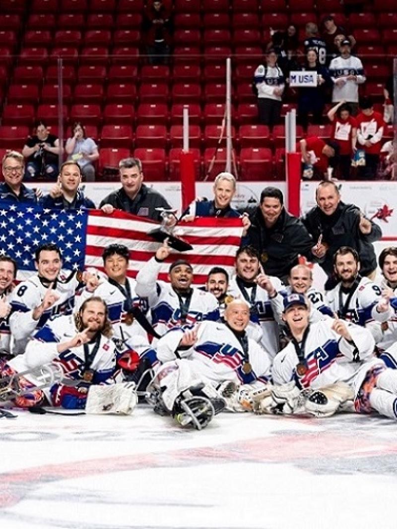 The USA Para ice hockey national team celebrating on ice at the Moose Jaw 2023 World Championships