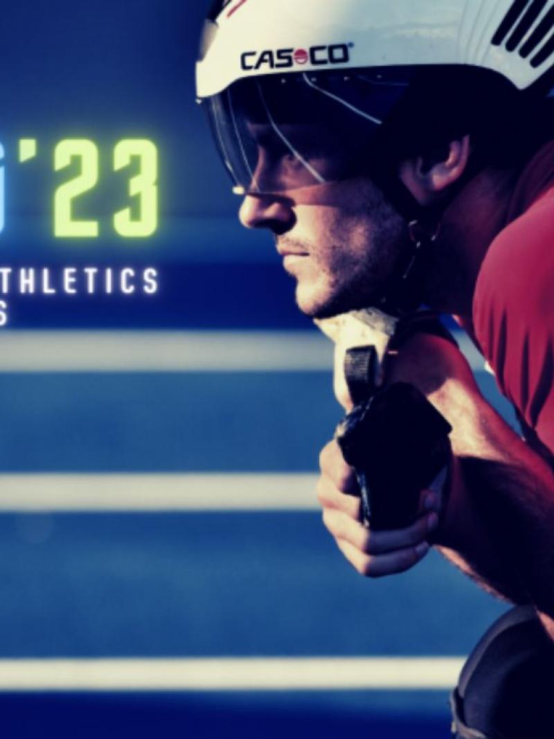 A men in a racing wheelchair on a blue athletics track