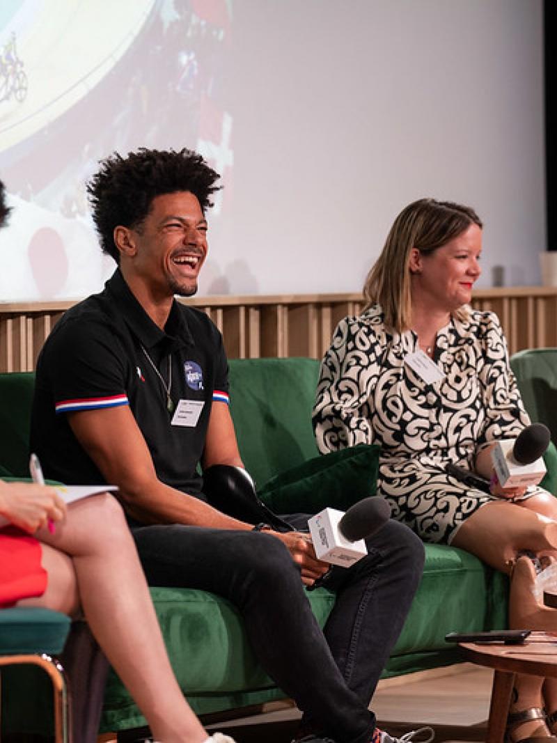 Four female and male Paralympians speak on stage.