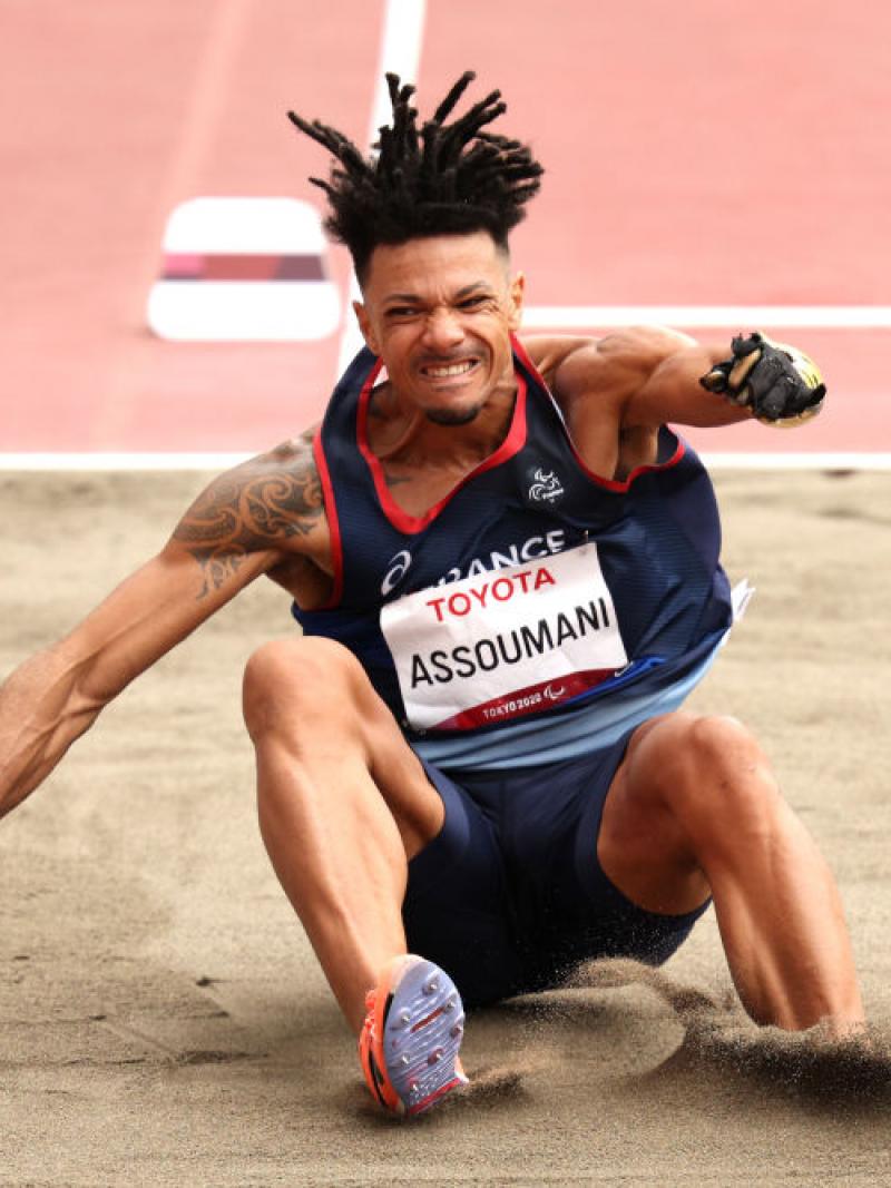 A male long jumper lands his jump at the Tokyo 2020 Paralympic Games.