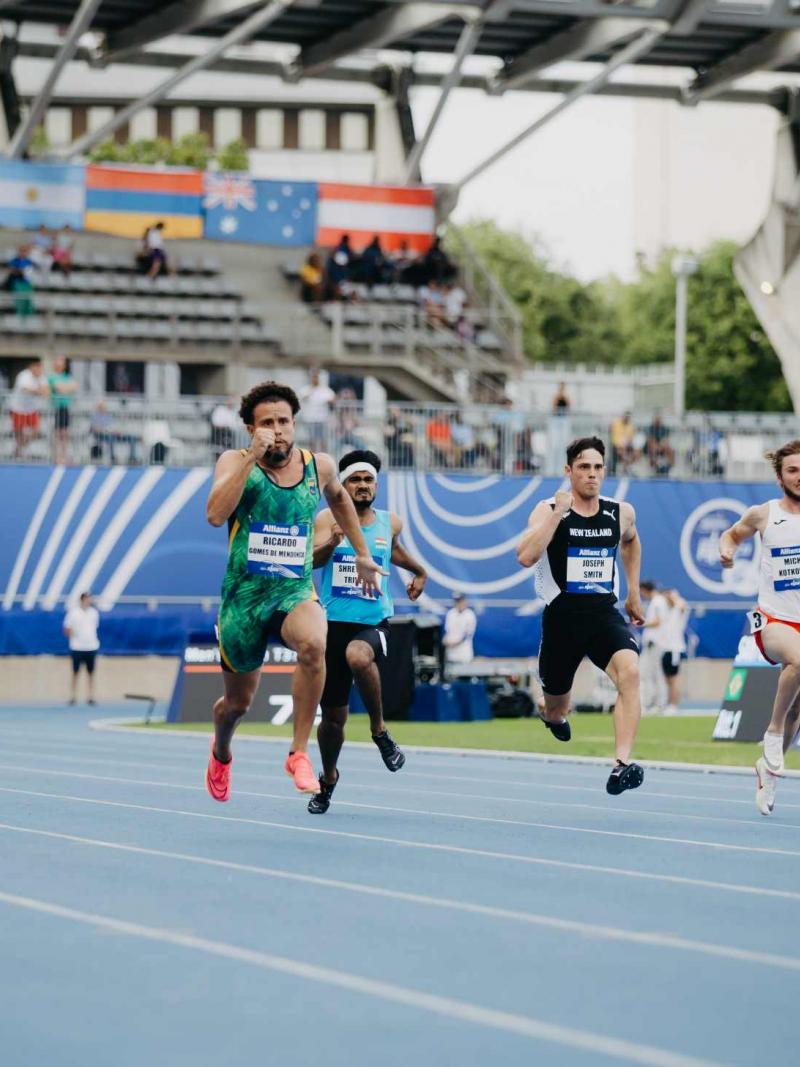 Five male sprinters in a Para athletics race
